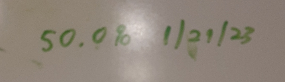 Green marker on whiteboard showing 50.0% and the date 1/29/23